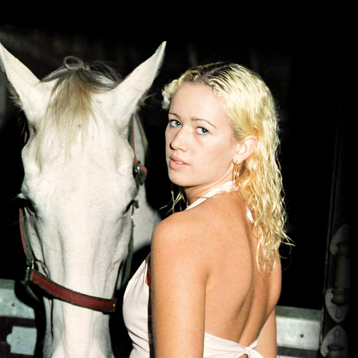 An example portfolio image of a female model with a horse